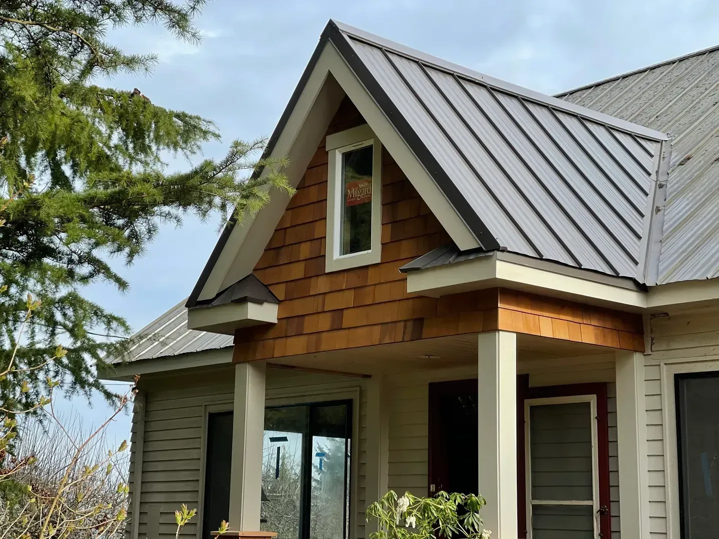 A house with a metal roof and wooden siding