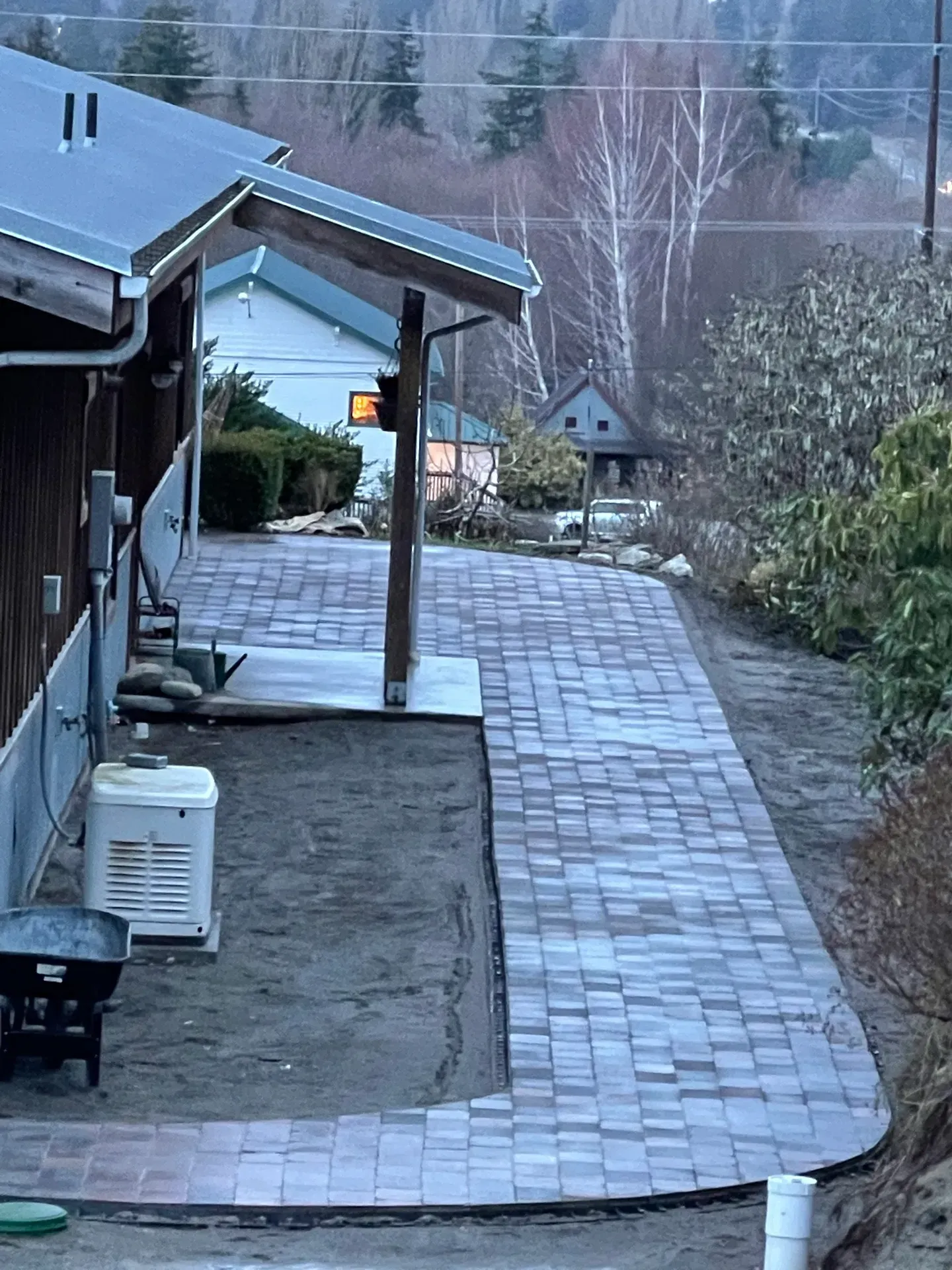 A brick walkway is being built in front of a house
