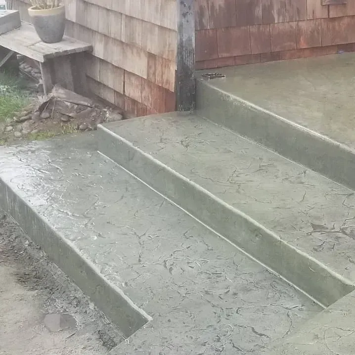 A set of concrete steps leading up to a house.