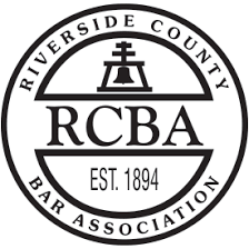 A black and white logo for riverside county bar association