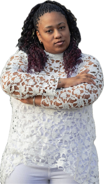 A woman in a white lace top is standing with her arms crossed.