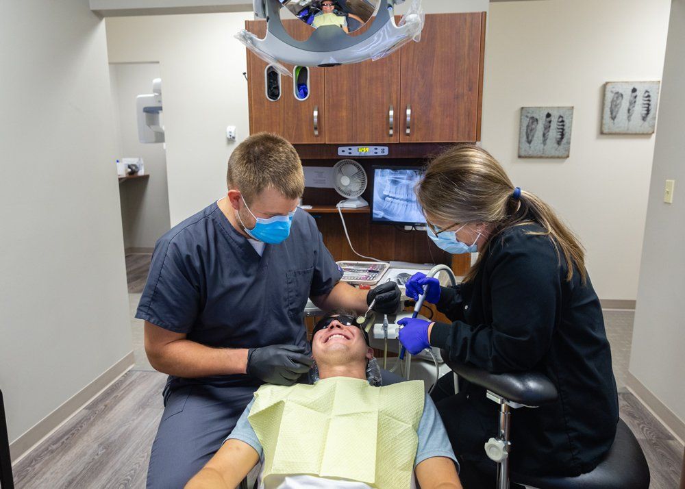 Ozone Treatments — Dentist and Assitant and Patient in Jasper, IN