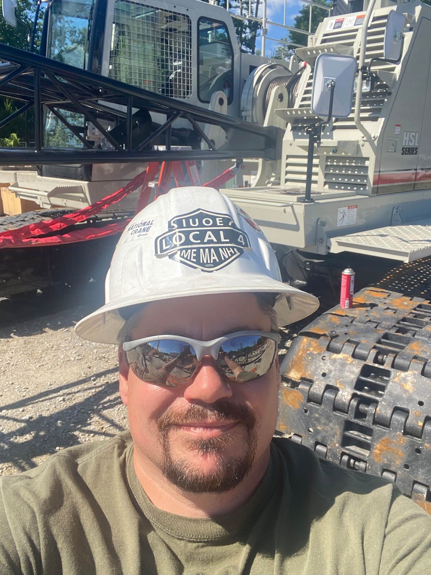 A construction worker is looking at a blueprint at a construction site.