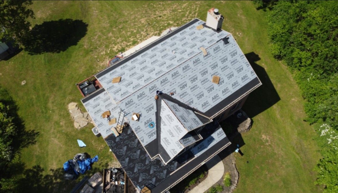 An aerial view of a house with a roof being installed.