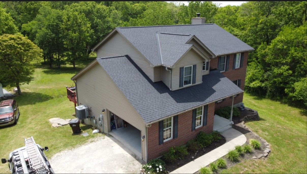 An aerial view of a house with a new roof.