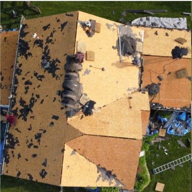 An aerial view of a roof that is being repaired