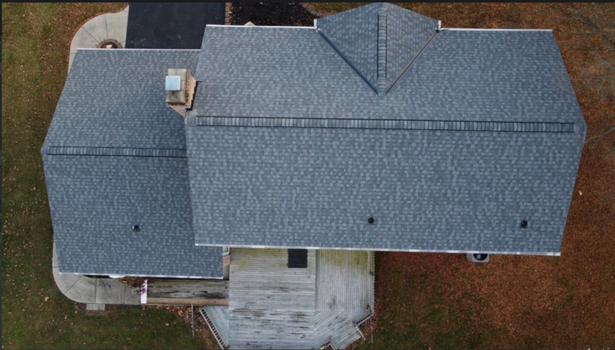 An aerial view of a house with a gray roof.