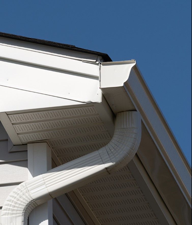 A white gutter on the side of a house