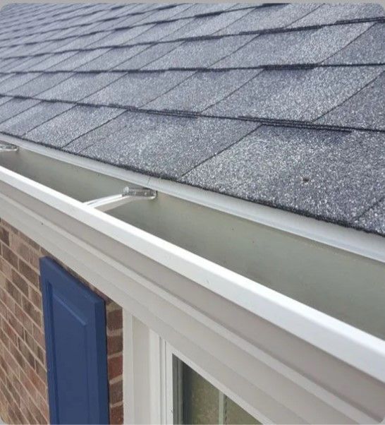 A close up of a gutter on the roof of a house.