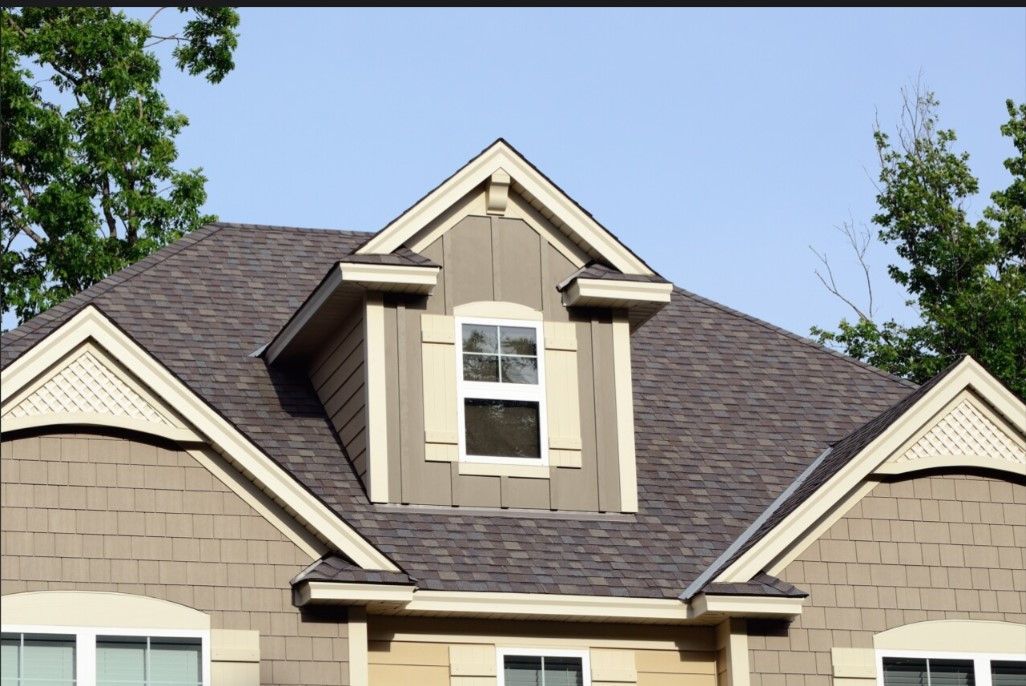 A house with a roof that has a window on it