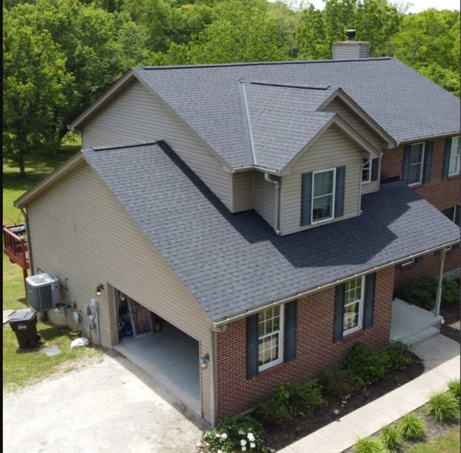 An aerial view of a house with a black roof