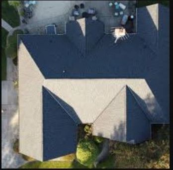 An aerial view of a house with a grey roof.