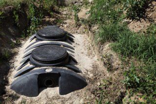 Black septic tank in ground - B & B Sewer & Septic Tank Service