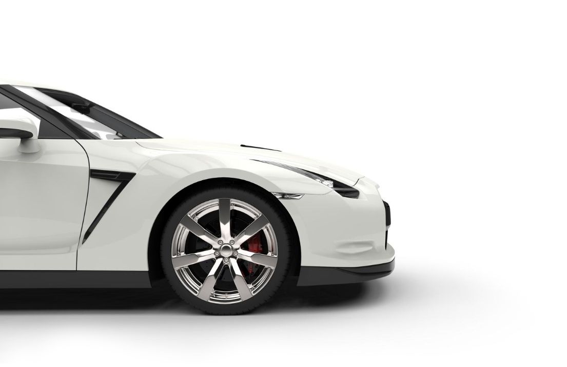 A white sports car is sitting on a white surface.