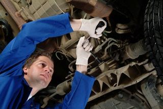 white man on blue repairing