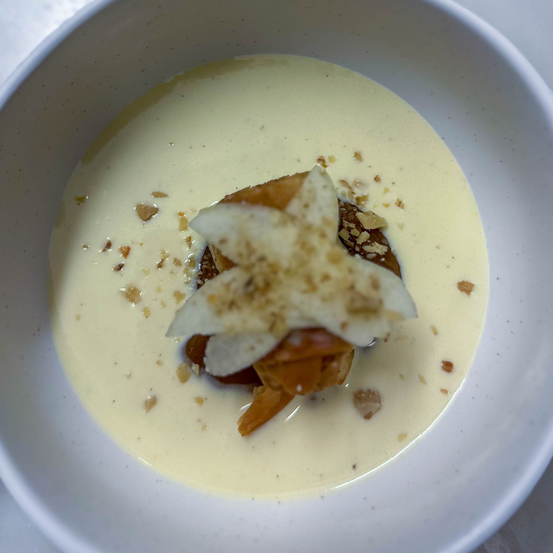 A bowl of soup with a starfish on top of it