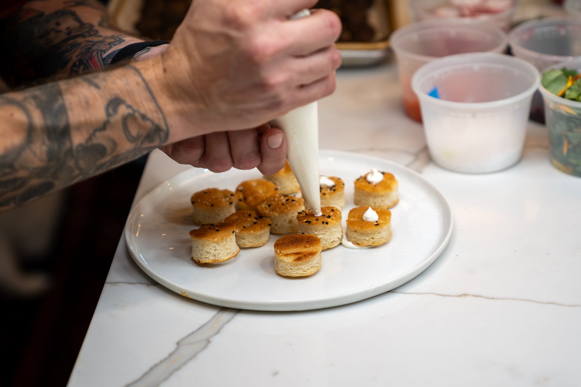 A person is decorating a plate of food with frosting.
