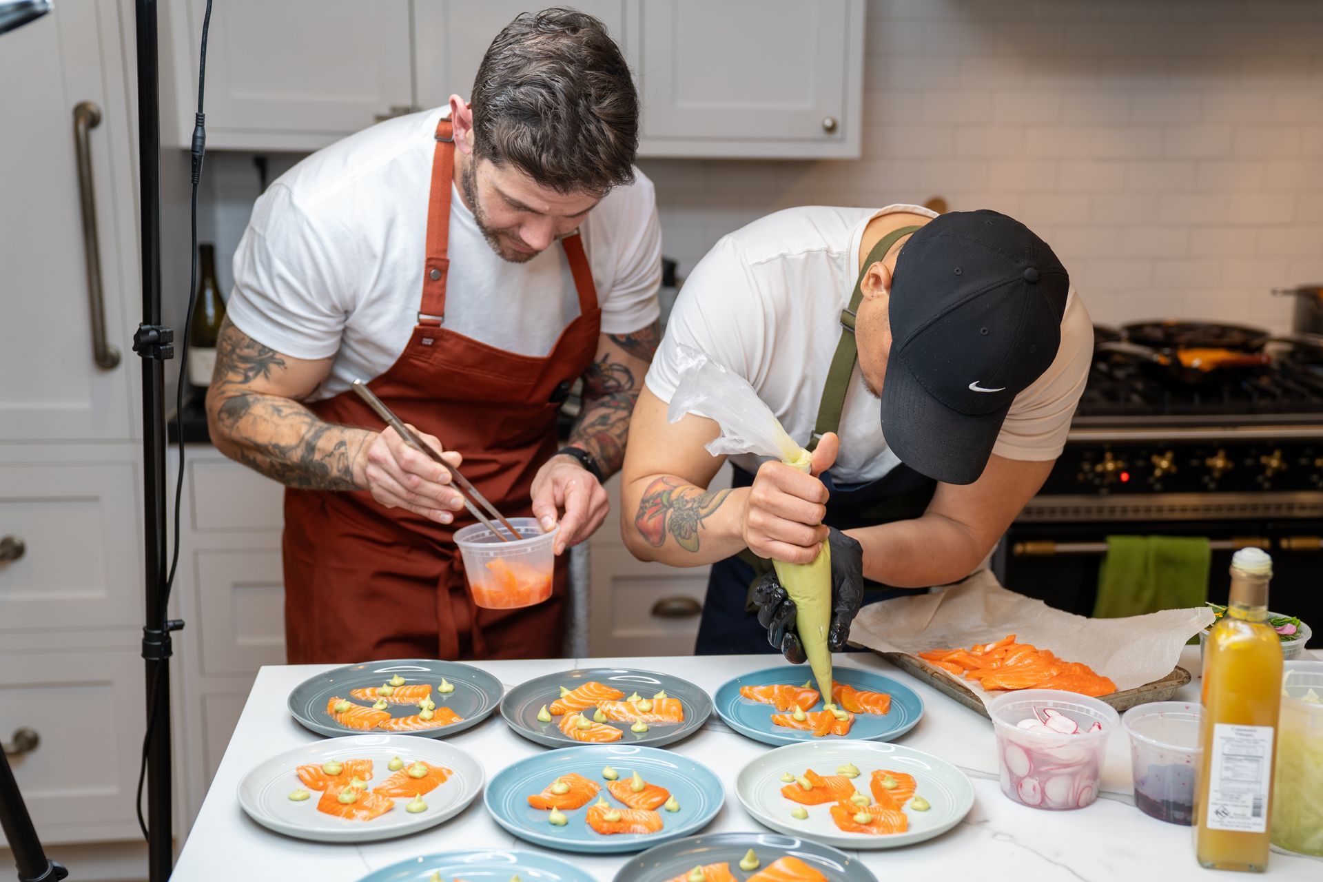 Two men are preparing food in a kitchen.
