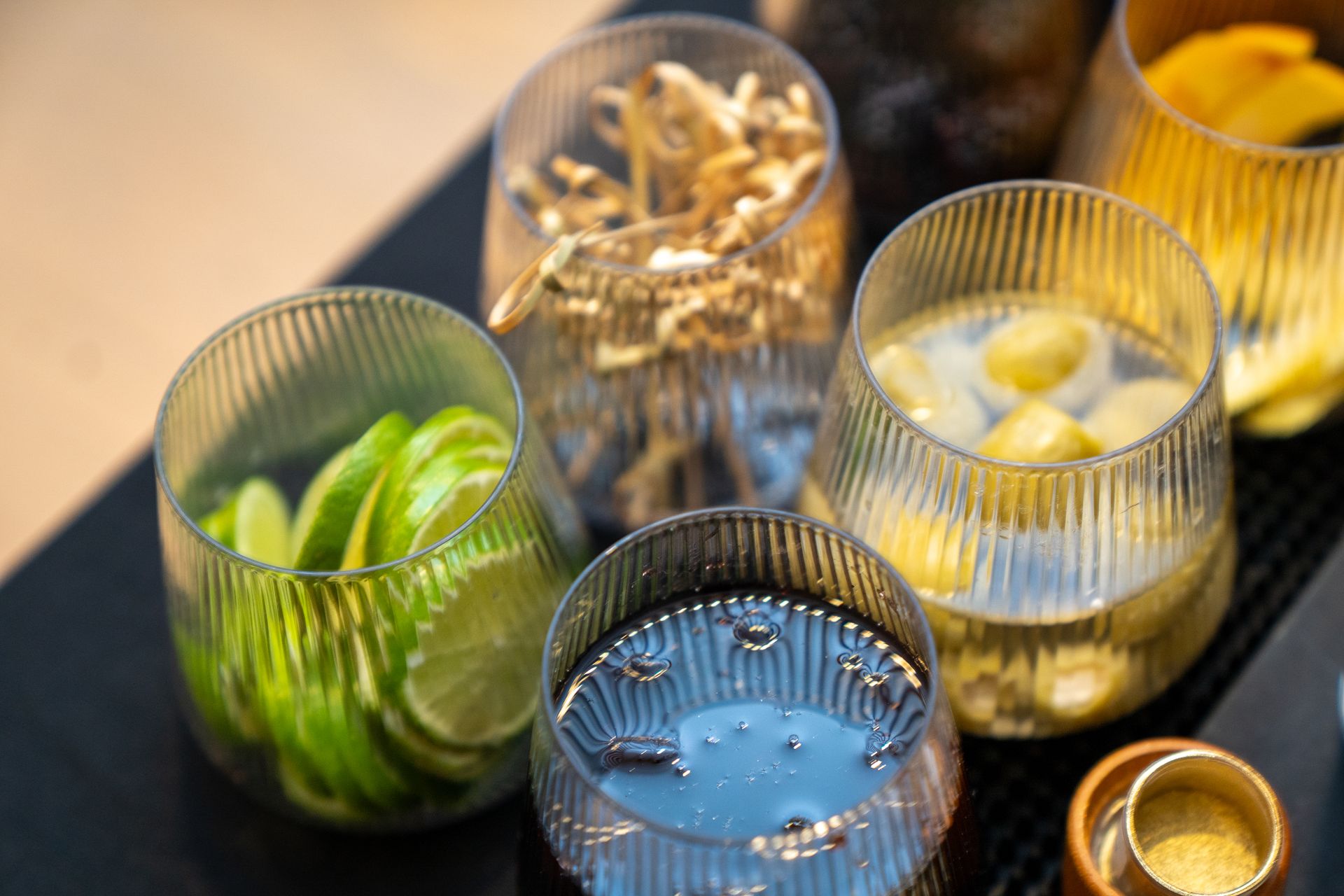 A table topped with glasses filled with different types of drinks.