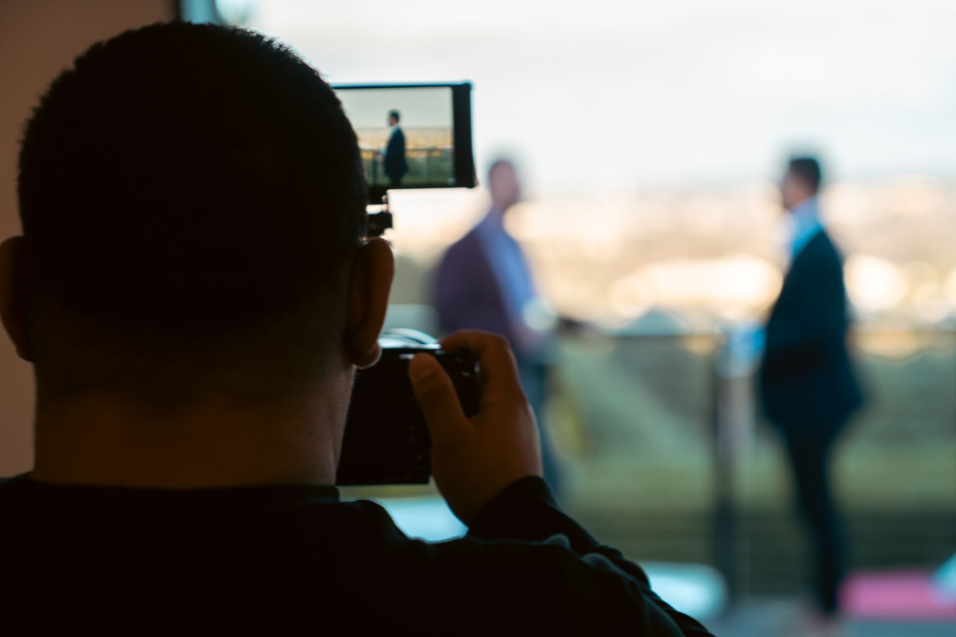 A man is taking a picture with a cell phone.