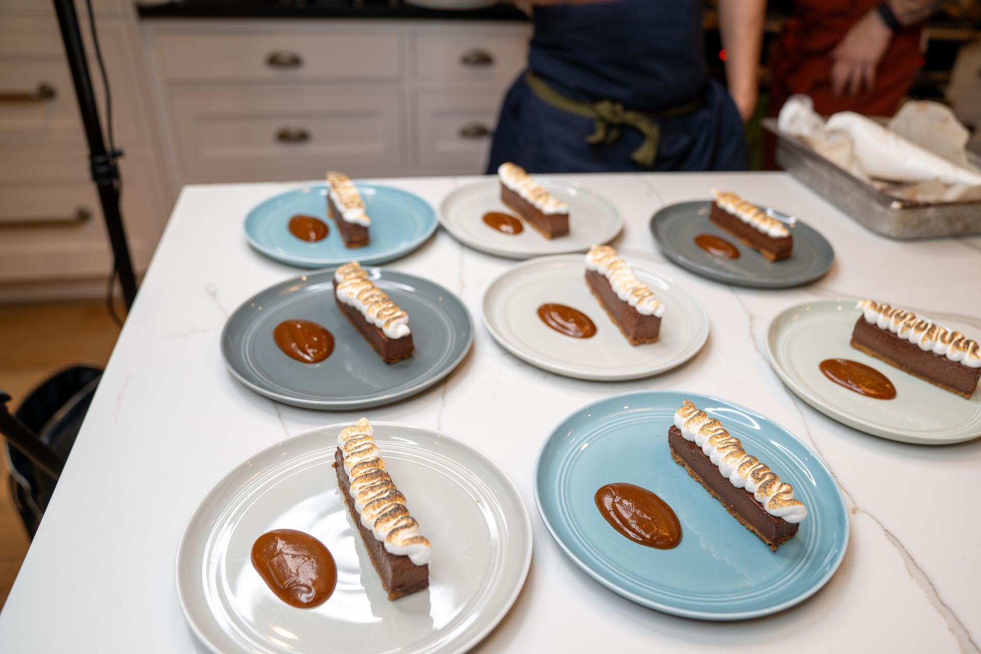 There are many different types of desserts on the plates on the table.
