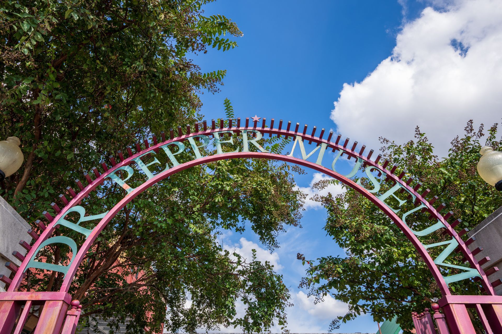 A pink archway with the words dr pepper museum on it