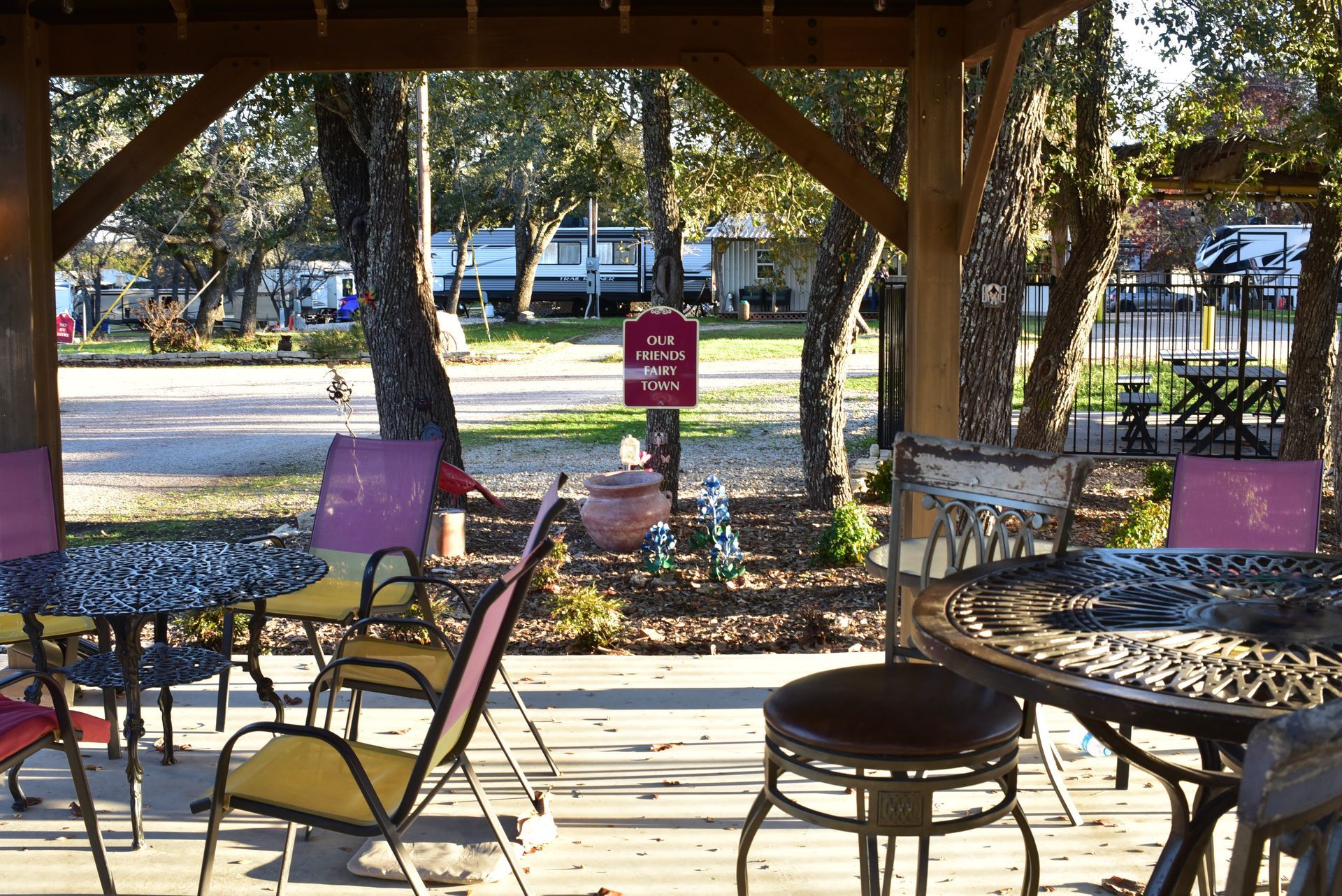 A patio area with tables and chairs under a gazebo