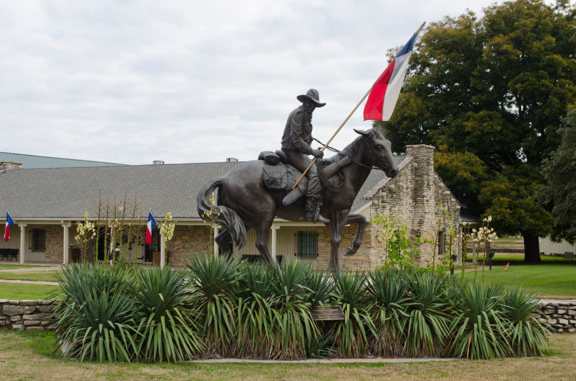 A statue of a man on a horse holding a flag