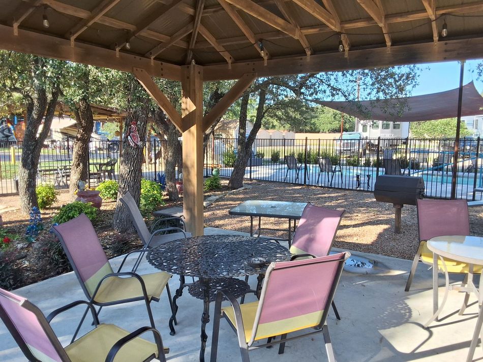 A gazebo with a table and chairs underneath it