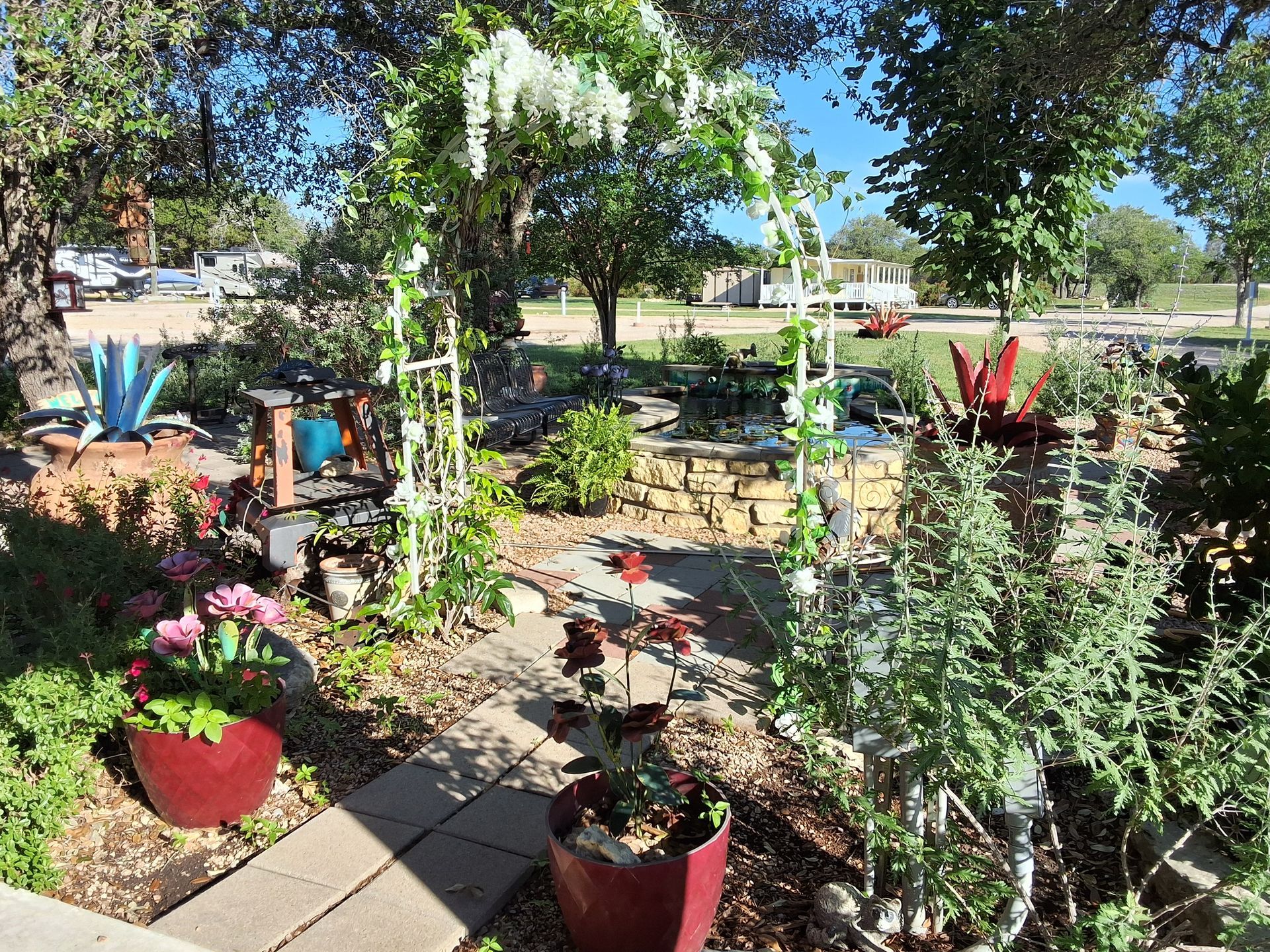 A garden with lots of potted plants and trees