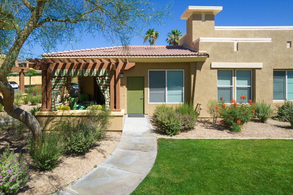A house with a green door and a walkway leading to it
