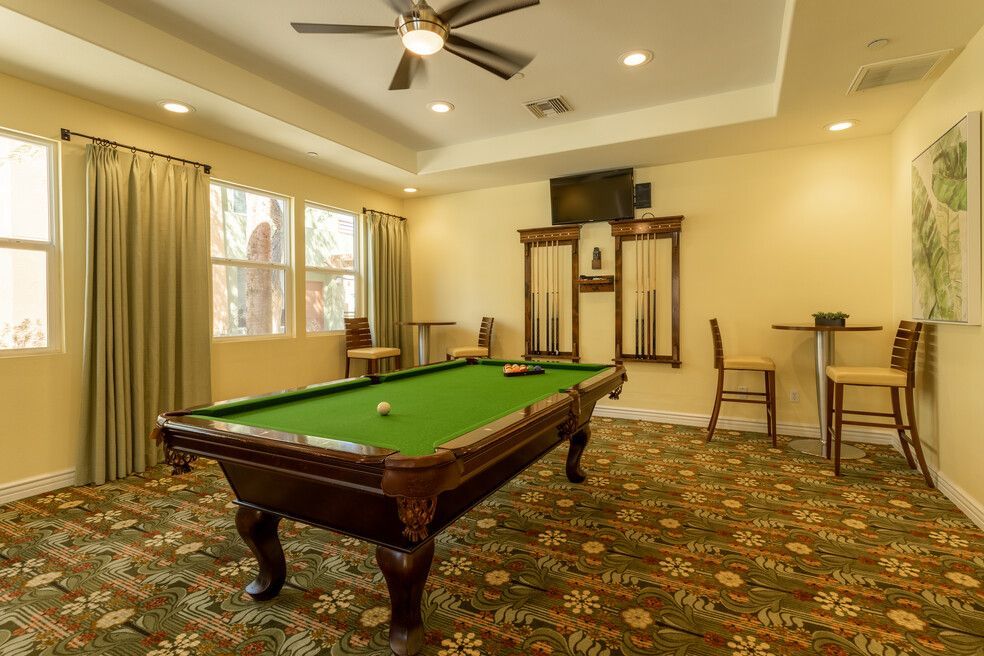 There is a pool table in the middle of the room.