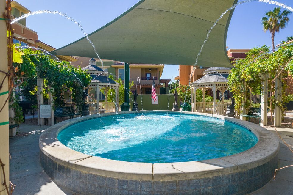 A large pool with a fountain in the middle of it