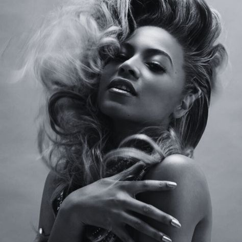 A black and white photo of a woman with long hair.