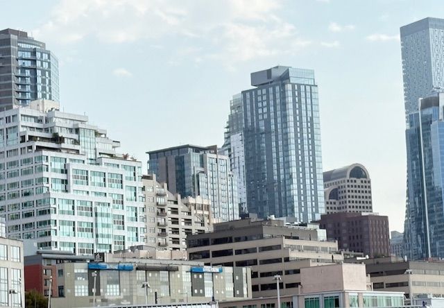 City skyline with several skyscrapers under a blue sky.