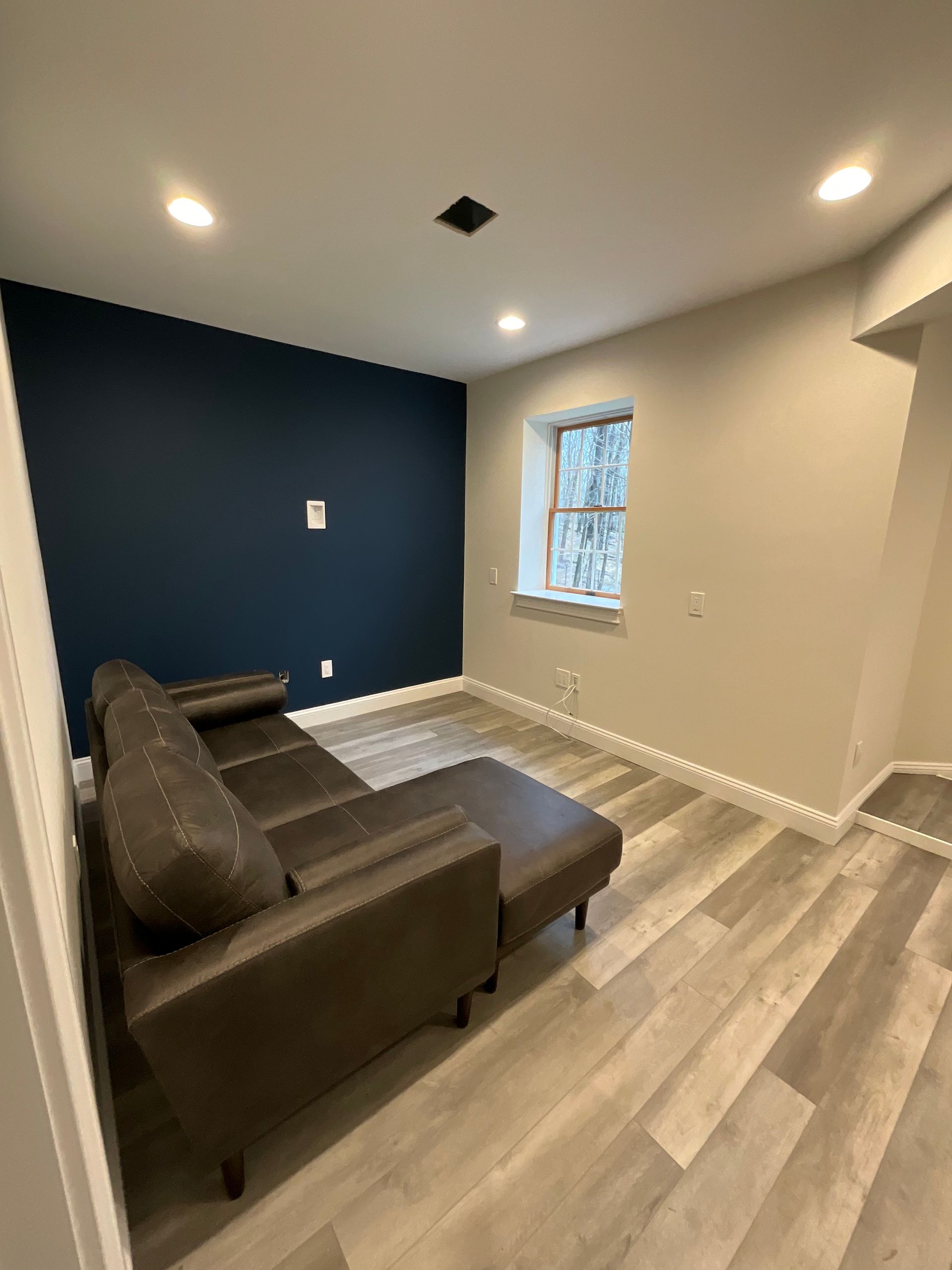 A large white brick house with black shutters on the windows