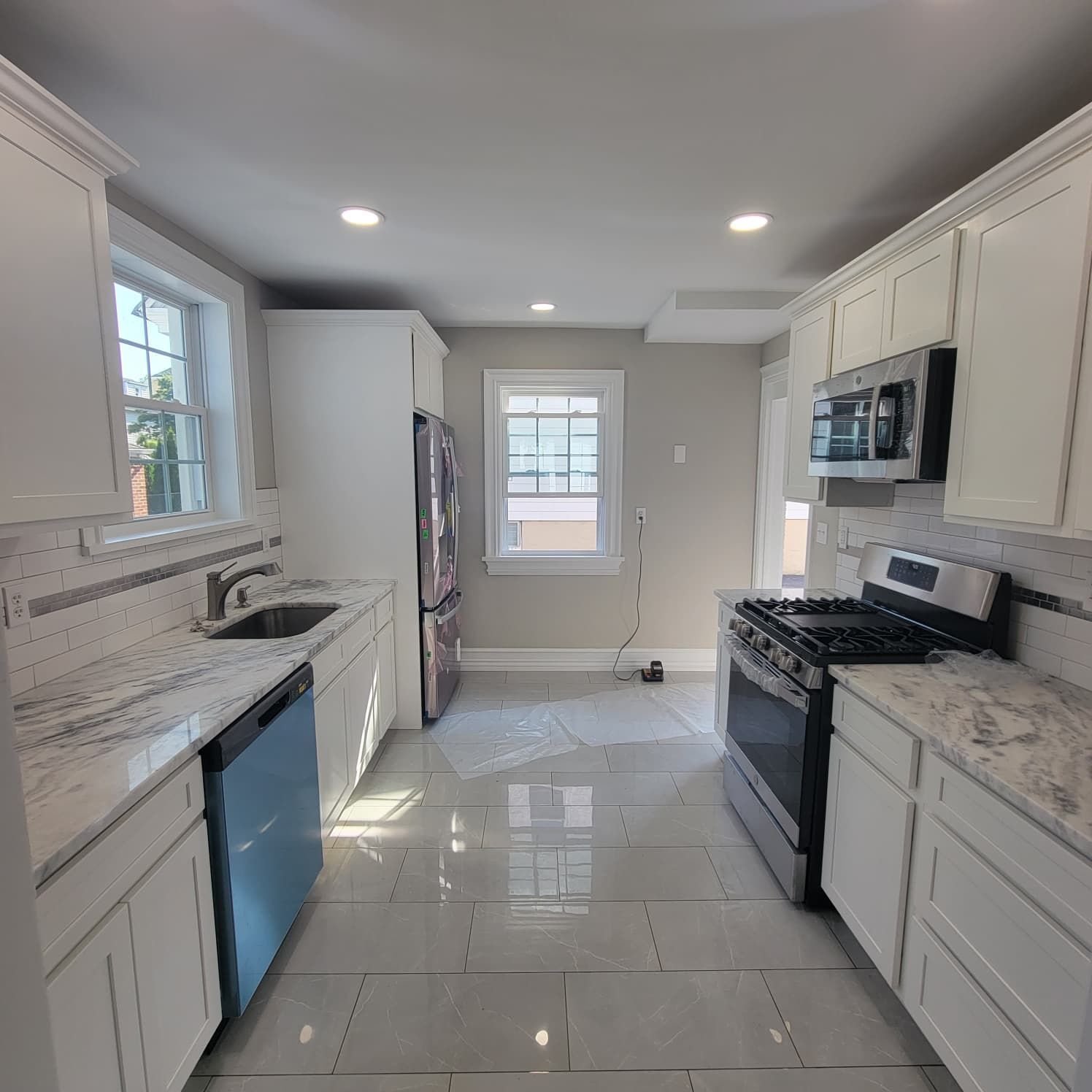 A bathroom with two sinks and a walk in shower.