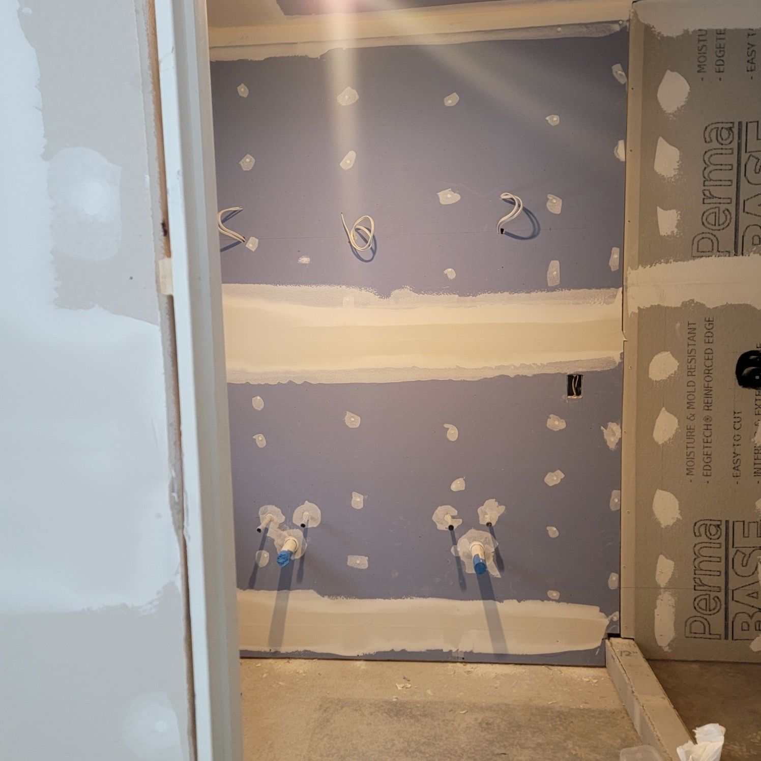 A room that is being remodeled with a blue wall