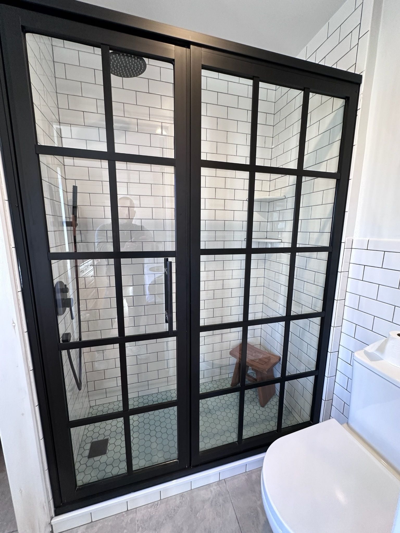 A bathroom with a walk in shower and a toilet