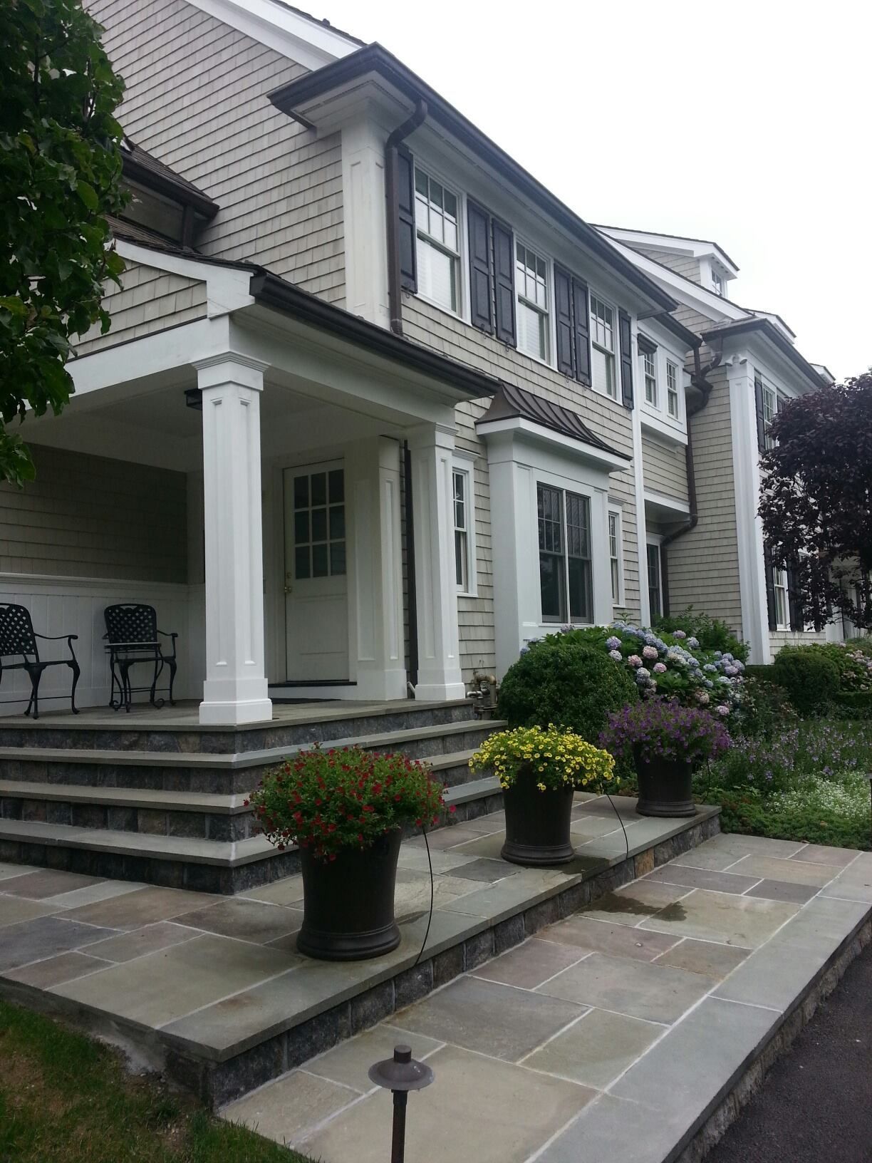 A large house with a large porch and stairs