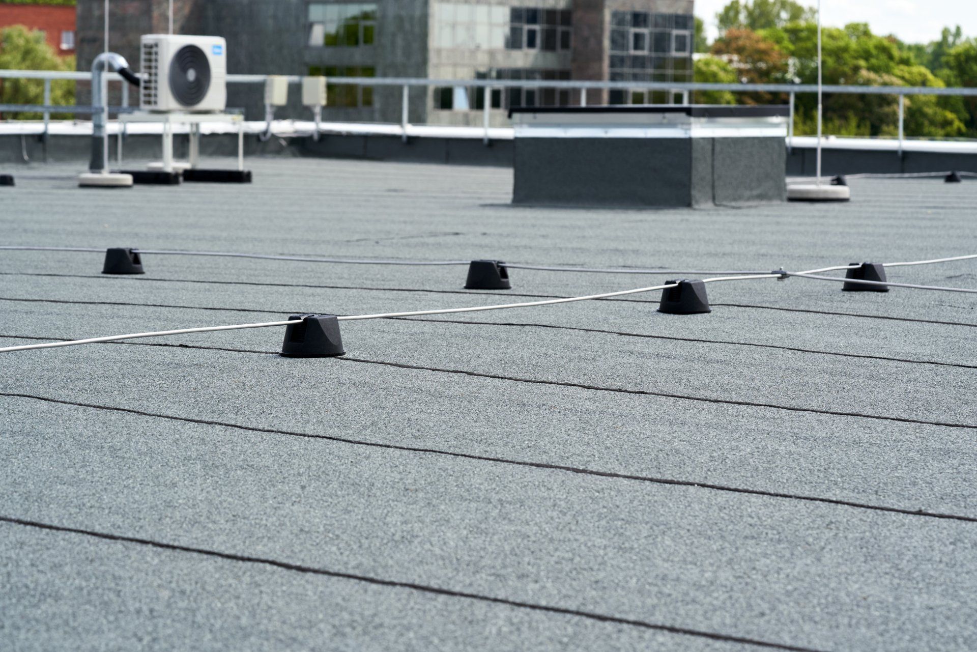 Flat roof covered with bitumen membrane for waterproofing.
