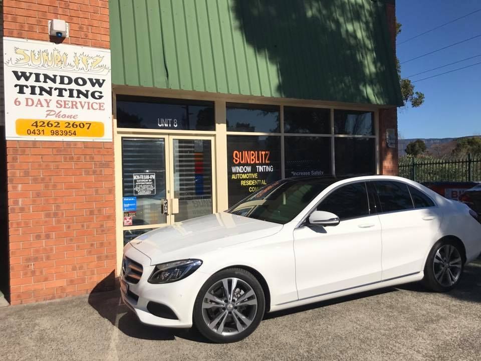 A Car With Tinted Windows Outside Of A Shop — Sunblitz Window Tinting In Dapto, NSW