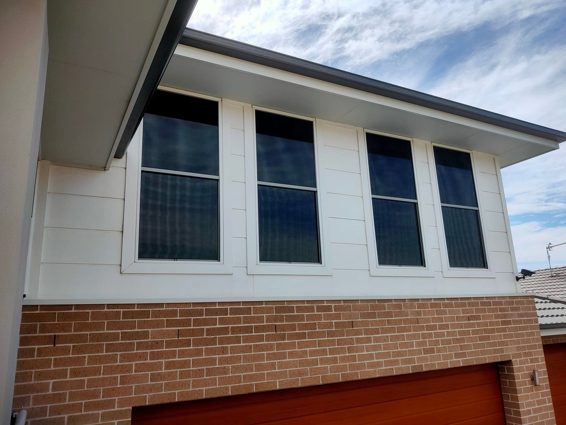 A Building With A Lot Of Tinted Windows — Sunblitz Window Tinting In Dapto, NSW