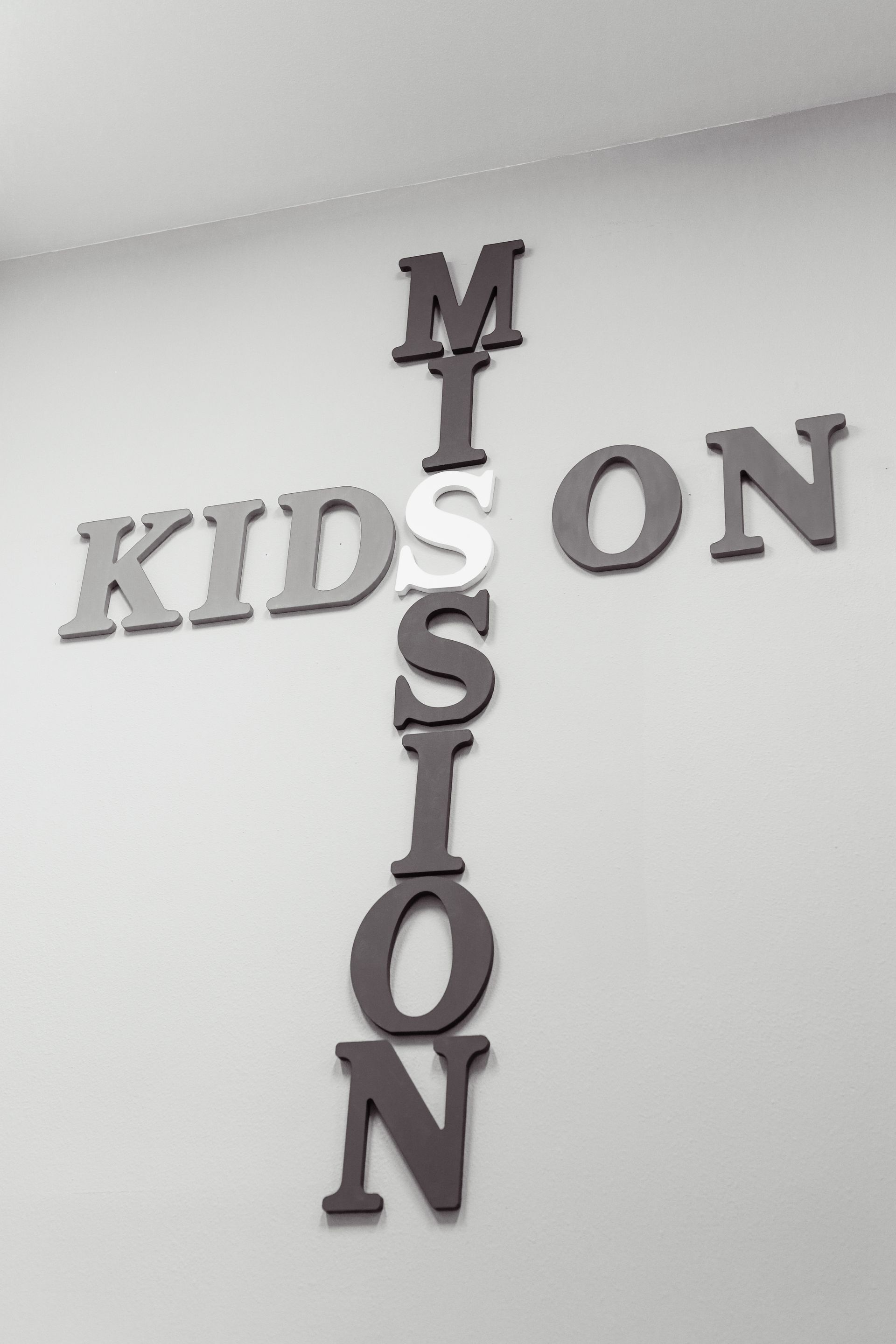 A woman is sitting on the floor reading a book.