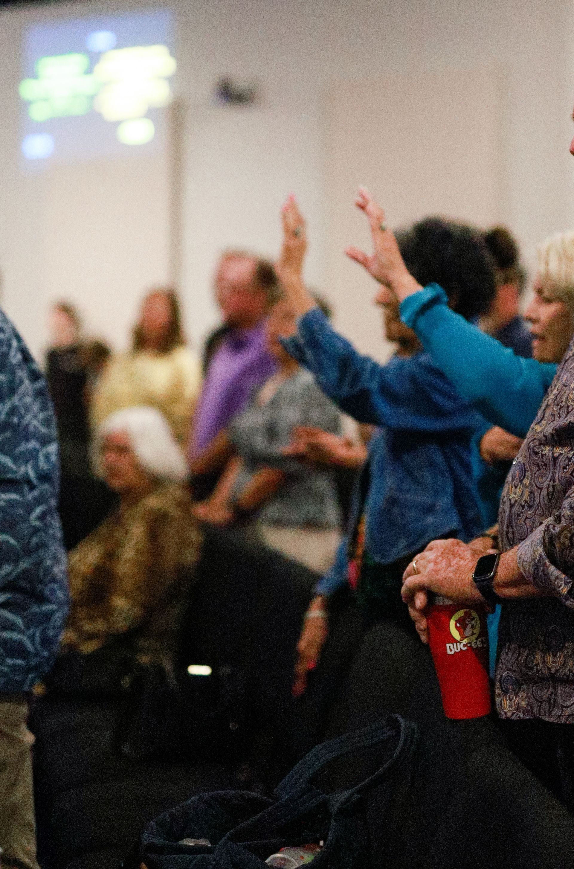 A group of people are posing for a picture in front of a body of water.