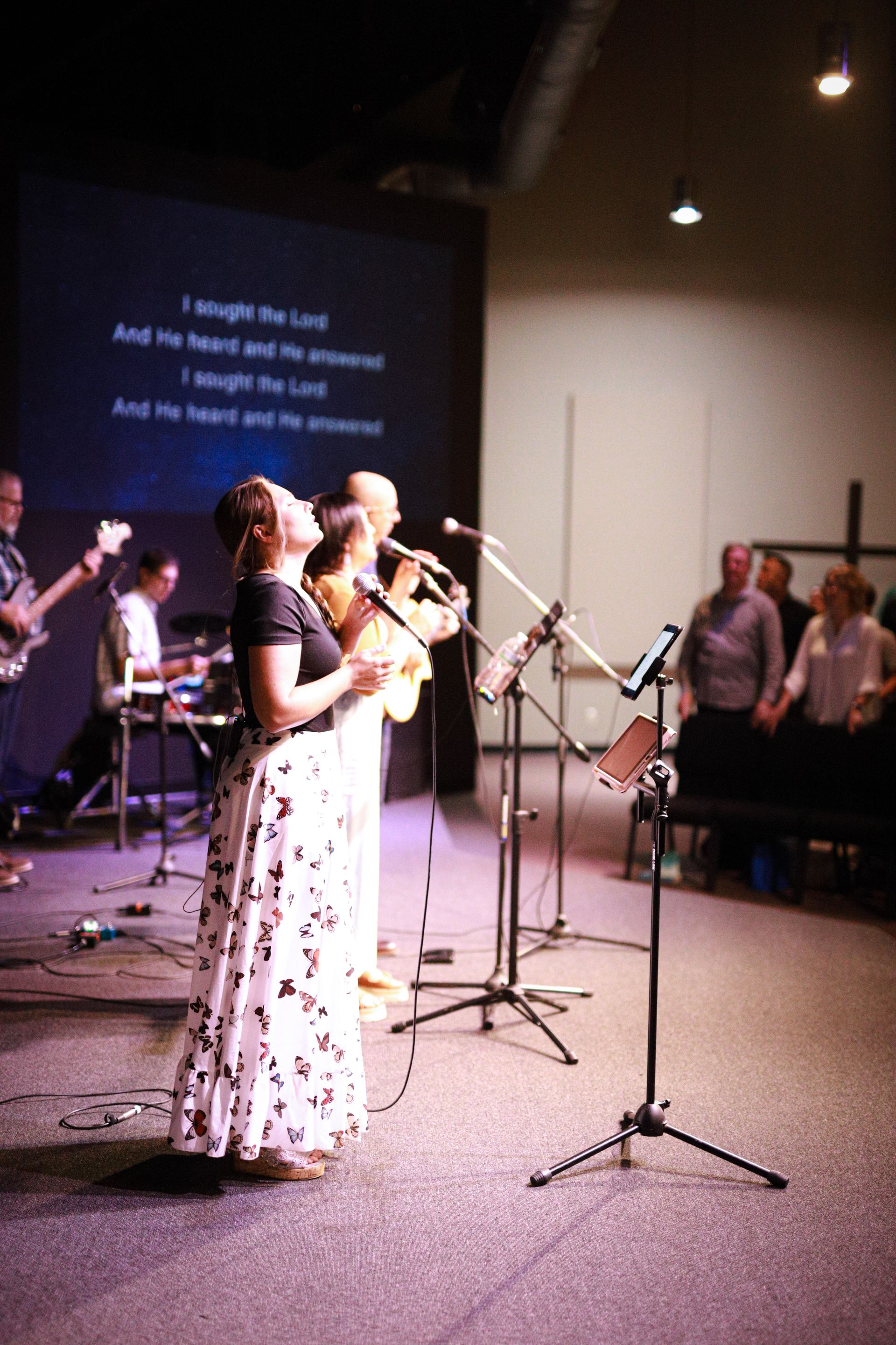 A group of people standing outside of a building holding hands
