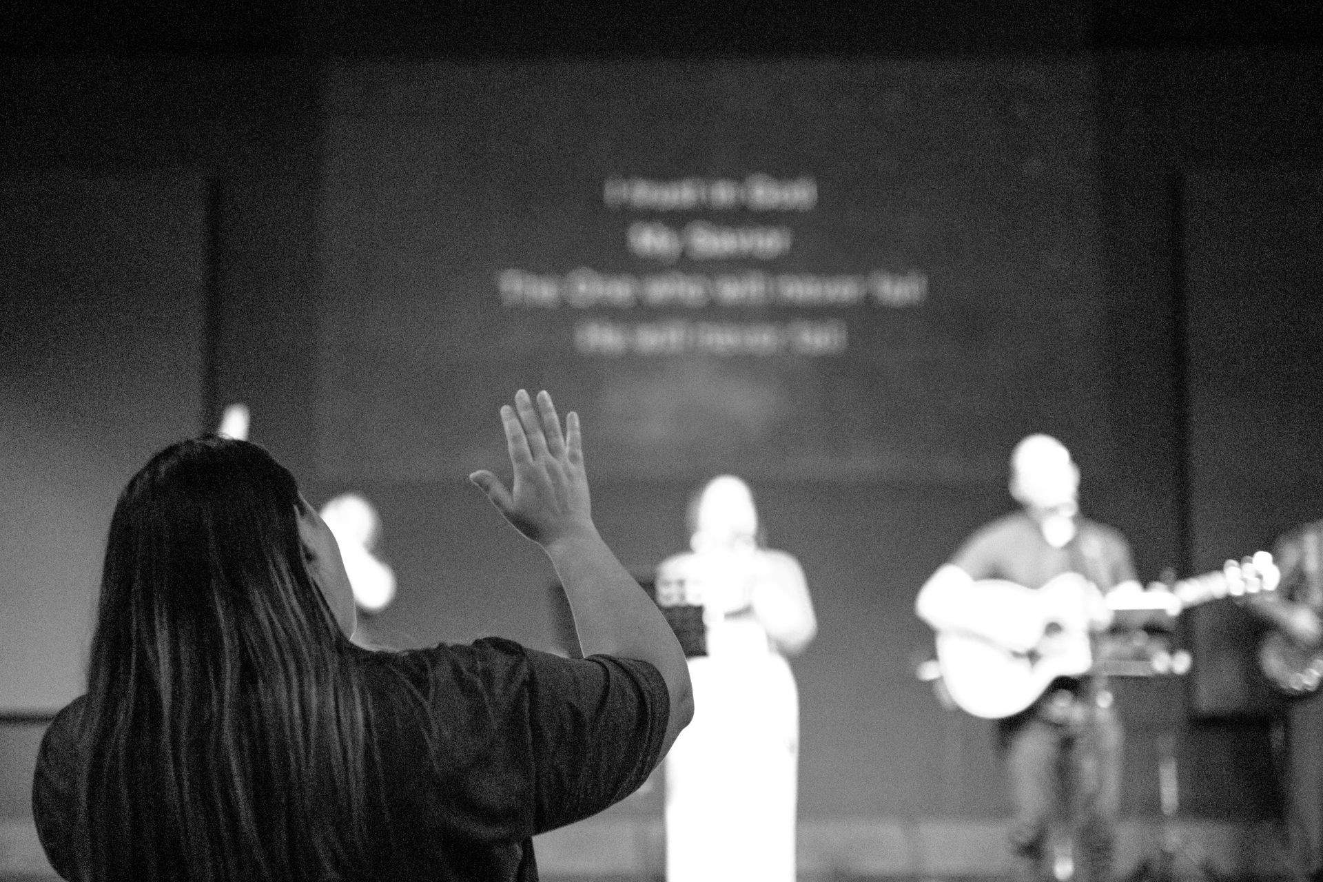 A black and white photo of a wall with a sign that says we gather together