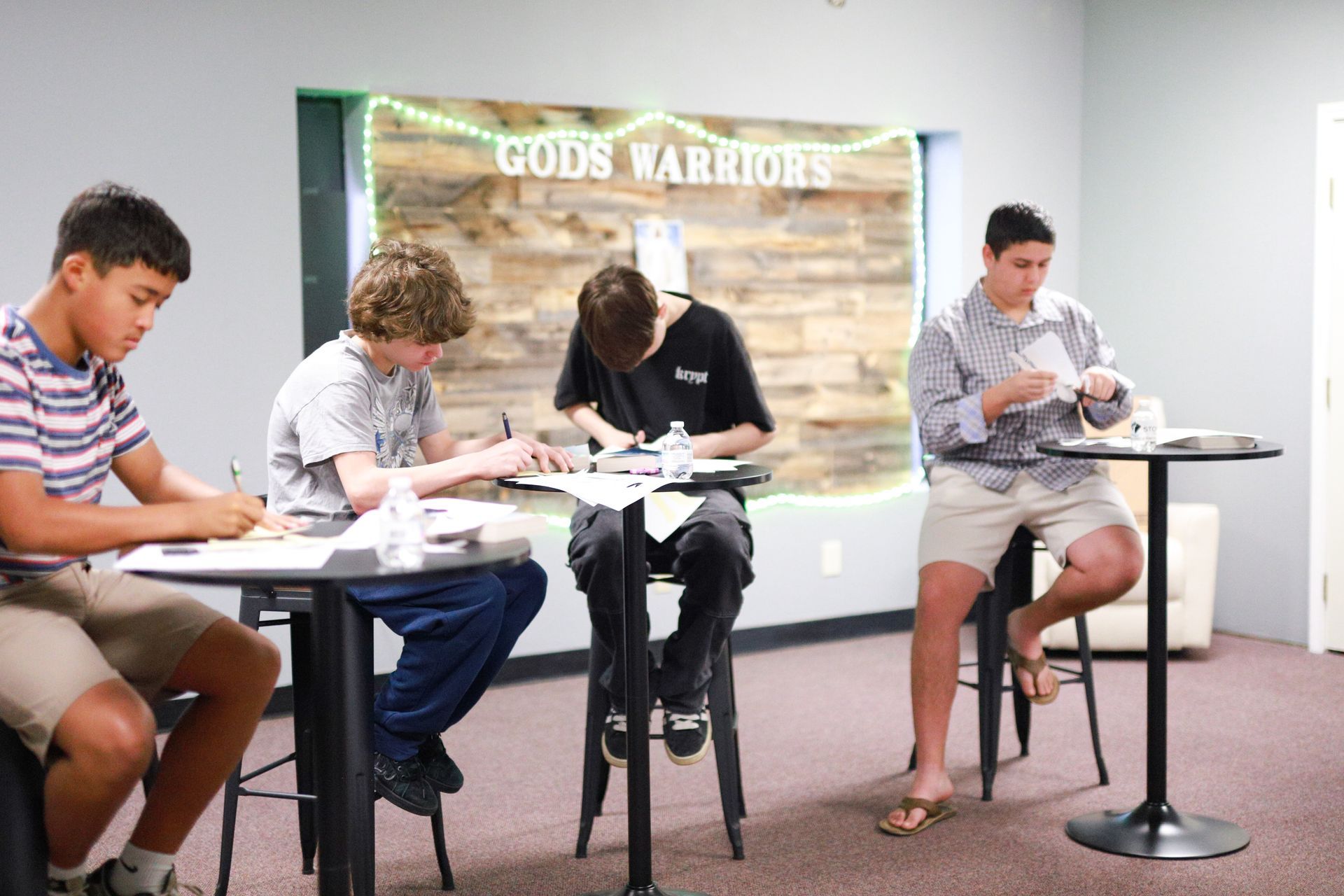 A group of people are posing for a picture in front of a body of water.