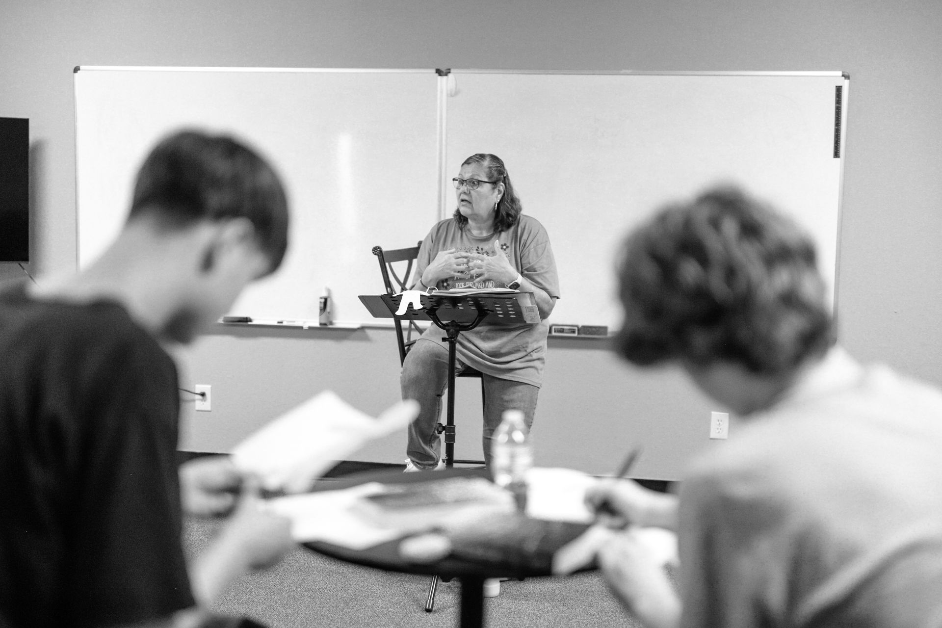 A person is reading a bible in a black and white photo.