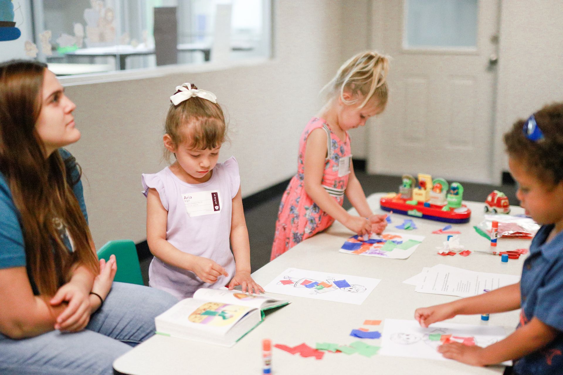 A group of children standing in front of a blackboard that says kids on mission